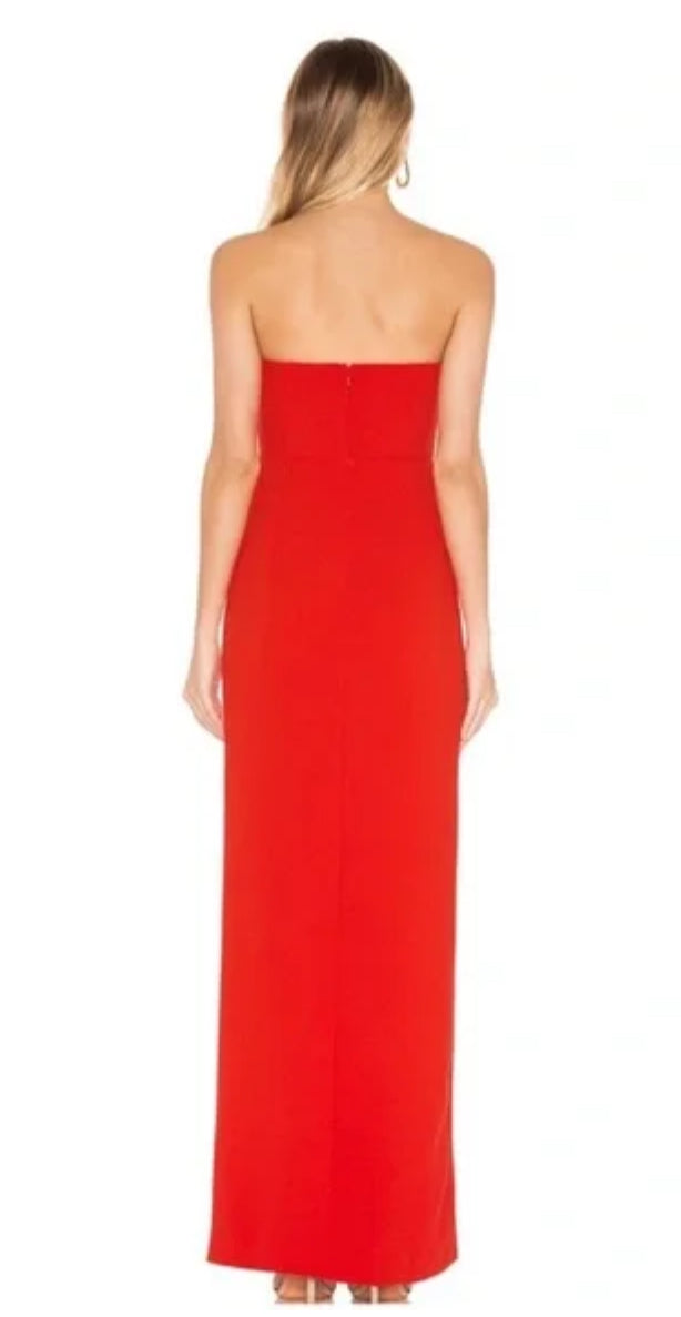 Woman wearing a strapless red evening gown on a white background