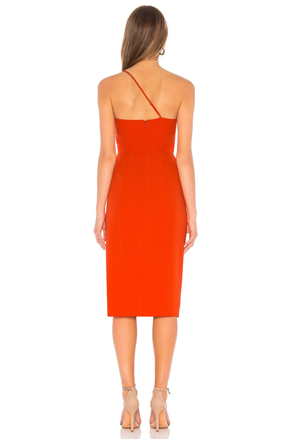 Woman wearing a bright orange dress on a white background