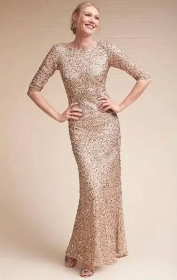 Model wearing the Adrianna Papell embellished mermaid gown with hands on her hips.