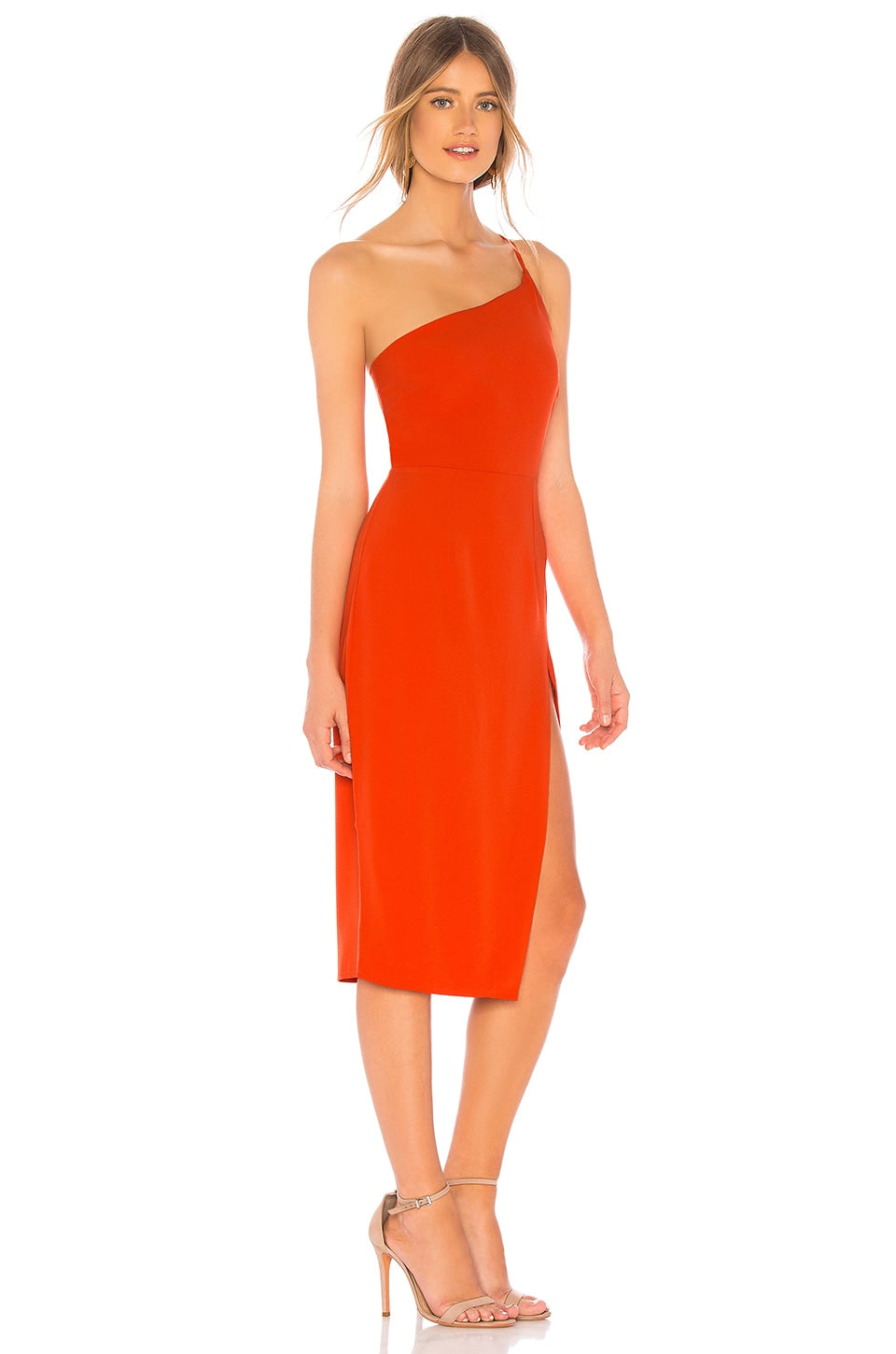 Woman wearing a bright orange one-shoulder dress on a white background